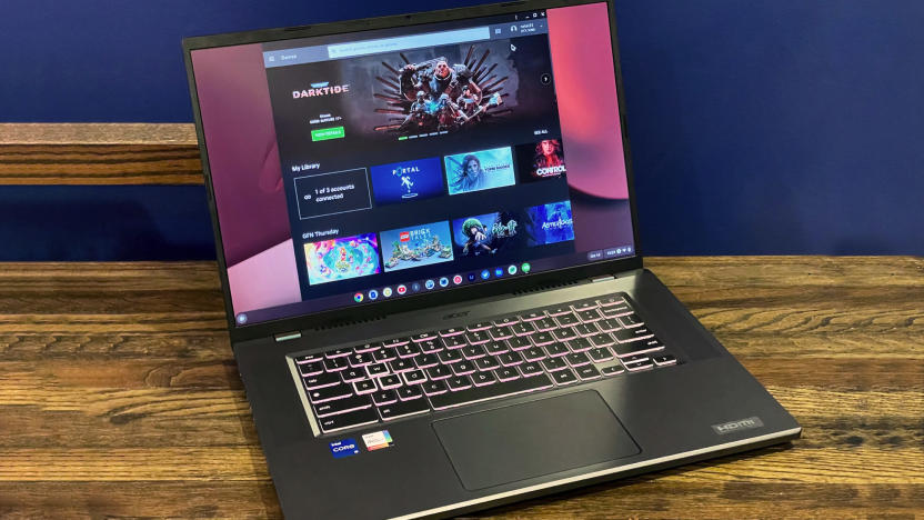 The Acer Chromeboko 516 GE  laptop seen open, facing the camera on a wooden desktop with a blue wall in the background.