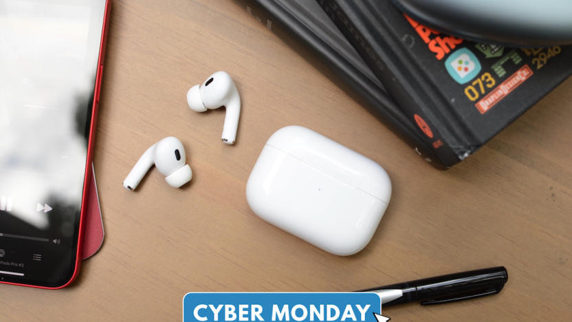 The Apple AirPods Pro laid on a desk with Cyber Monday logo.