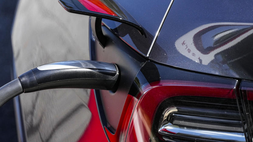 File - A Tesla vehicle receives a charge at a charging station, Sept. 28, 2023, in Woodstock, Ga. Tesla is expected to report fourth quarter and full year sales Tuesday as electric vehicle sales growth continues to slow. (AP Photo/Mike Stewart, File)