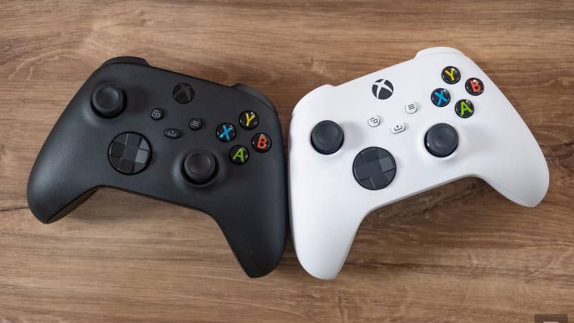 Two Xbox Wireless Controllers, one black and the other white.