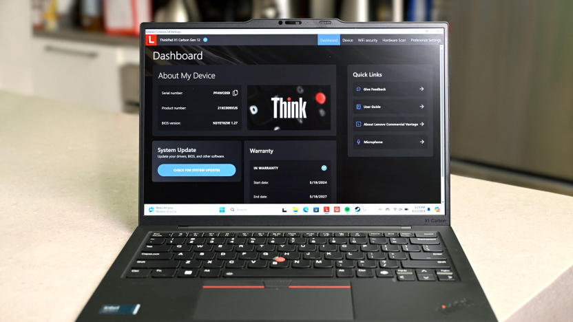 The Lenovo ThinkPad X1 Carbon (12th-gen) with its screen and keyboard facing the camera. On its display is Lenovo's Think dashboard showing information about the device, including system update and warranty.