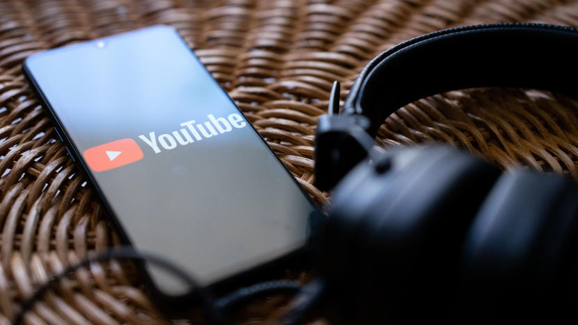 Headphones connected to a mobile phone with the logo of You tube on its screen. (Photo by Nikos Pekiaridis/NurPhoto via Getty Images)