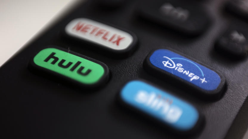 FILE - The logos for streaming services Netflix, Hulu, Disney Plus and Sling TV are pictured on a remote control on Aug. 13, 2020, in Portland, Ore. Walt Disney Co. said it will acquire a 33% stake in Hulu from Comcast for approximately $8.6 billion, a deal that will give Disney undisputed control of the streaming service. (AP Photo/Jenny Kane, File)