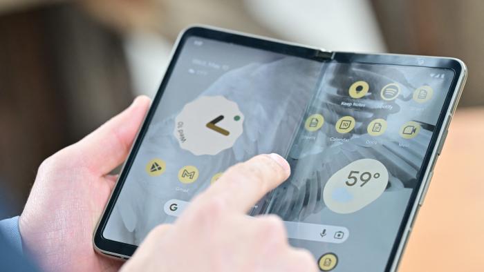 Members of the media view the new Google Pixel Fold phone during the Google I/O annual developers conference at Shoreline Amphitheatre in Mountain View, California on May 10, 2023. (Photo by Josh Edelson / AFP) (Photo by JOSH EDELSON/AFP via Getty Images)