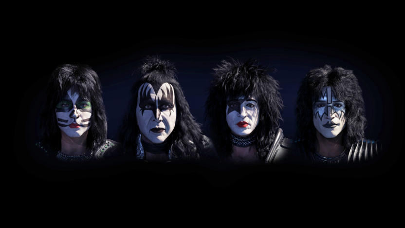 Digital avatars of Kiss current band members, Paul Stanley, Gene Simmons, Tommy Thayer and Eric Singer showing just their faces against a black background.