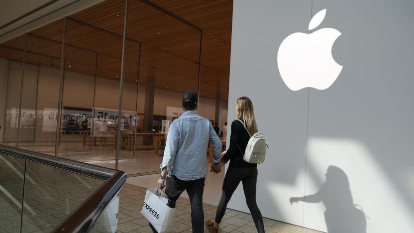 People walk by an Apple store Oct. 20, 2023, in Denver. Apple is now requiring that U.S. law enforcement agencies obtain a court order for information on its customers' push notifications â the alerts iPhone apps send users that can reveal a lot about their online activity. (AP Photo/Brittany Peterson, File)