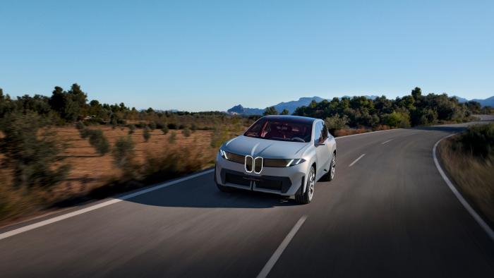 The BMW Vision Neue Klasse X concept electric car on a road that's slightly curving.