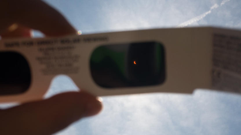 Eclipse being viewed through glasses.